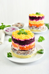 Layered salad with beet, herring, carrots and potatoes