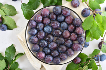 Fresh plums on plate
