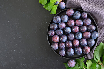 Fresh plums on plate