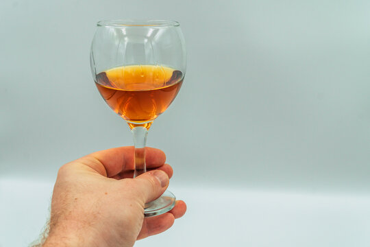 a glass of cognac in hand