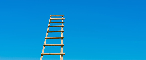 Development, Attainment ,Motivation. Career Growth Concept.Wooden Ladder Leading To A Blue Bright Sky.Copy space.Banner,advertisement.