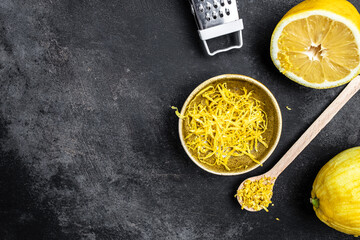 Yellow Organic lemons, zest and special tool. Grater peel and lemon zest on dark background, Long...