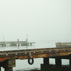 foggy dock. pier, autumn silence. calm. fishermen.