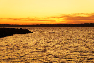 sunset by the water. beautiful view of the river. coast.