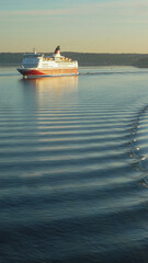 Viking passenger toro ferry sailing during twilight sunrise blue hour dusk through Stockholm archipelago with orange sky