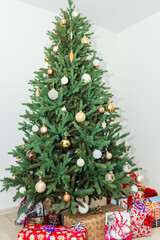 Christmas Gifts wrapped in miscellaneous red paper, background blurred under Christmas tree..