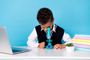 Photo of cute adorable small boy wear black waistcoat sitting table making biological investigation...