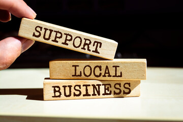 Wooden blocks with words 'Support Local Business'. Business concept