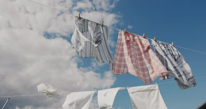 Two ropes with clothes drying against the blue sky