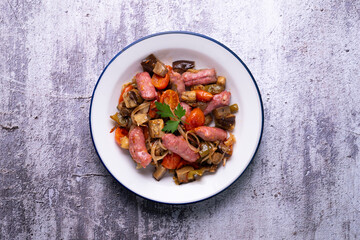Iberian pork sausages sautéed with vegetables. Tapa typical center of Spain.