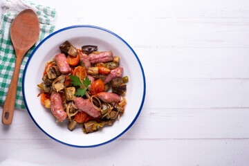 Iberian pork sausages sautéed with vegetables. Tapa typical center of Spain.