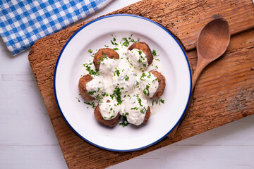 Pork meatballs with Greek tzatziki sauce with cucumber and yogurt. Traditional Greek recipe.