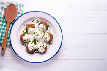 Pork meatballs with Greek tzatziki sauce with cucumber and yogurt. Traditional Greek recipe.
