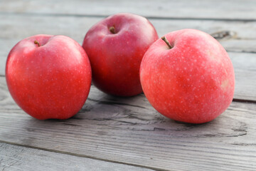 Red ripe apples on a rustic gray wooden boards. Copy space