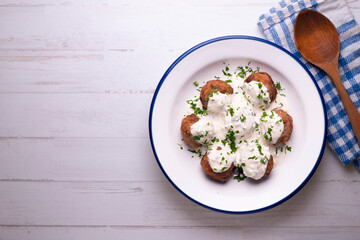 Pork meatballs with Greek tzatziki sauce with cucumber and yogurt. Traditional Greek recipe.