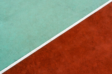 White line dividing rubber stadium surface into to colors