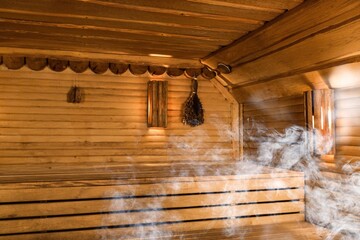 Interior of wooden sauna with hot white smoke steam.