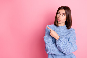 Fototapeta premium Portrait of impressed pretty lady look indicate finger empty space isolated on pink color background