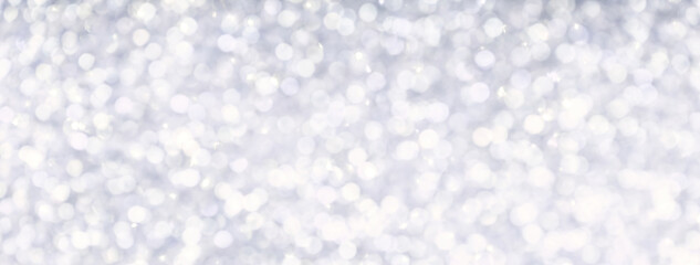 Blurred light silver sparkling background from small sequins, macro. Brilliant and diamond pearl...