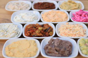 
​Meze or mezze is a selection of small dishes served as appetizers in much of West Asia, Middle East, and the Balkans. Meze is often served as a part of multi-course meals.