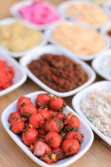 Meze or mezze is a selection of small dishes served as appetizers in much of West Asia, Middle East, and the Balkans. Meze is often served as a part of multi-course meals.