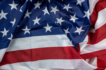 beautiful flag of the United States of America laid out textured on a plain background.