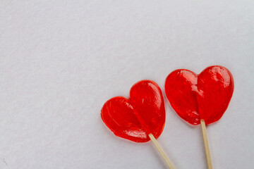 Two red heart lollipops on white background. Love and valentines day concept.
