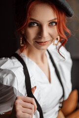 A beautiful girl in a white shirt and suspenders. The gaze is straight