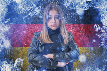 Teenage girl on frozen background with flag of Germany. Concept of crisis in Europe in winter. Energy crisis.