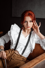 A beautiful girl in a white shirt and suspenders. The gaze is straight