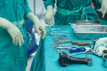 Assistant Orthopedic doctor preparing instruments for operation bone on the table. keeping the...