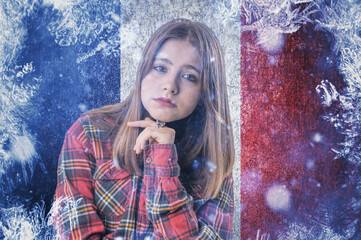 Teenage girl on frozen background with flag of France. Concept of crisis in Europe in winter....