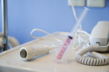 Liquid medicine in a cup with the patient's oral syringe,water pills for children