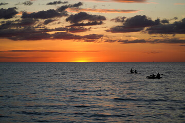 orange sun is sinking behind the beautiful sea in Thailand.