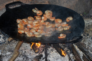 Shrimps cooked in the iron cast pan.