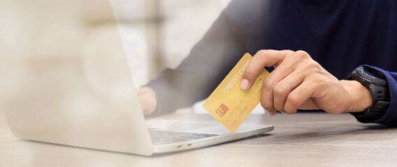 Businessman holding credit card for online shopping bill on smartphone, positive man shopping online remote payment , smart payment concept individual bank