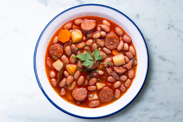 Asturian bean stew. Traditional recipe from the north of Spain with broad beans and chorizo.