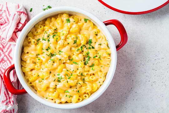 Mac and cheese in red pot. Traditional American food.