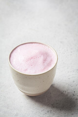 Pink flower moon milk in white cup. Ayurveda drink, healthy lifestyle, remedy for insomnia.