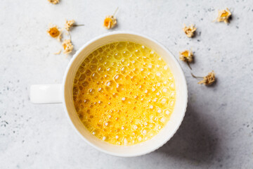 Golden turmeric chamomile moon milk in white cup. Ayurveda drink, healthy lifestyle, remedy for...