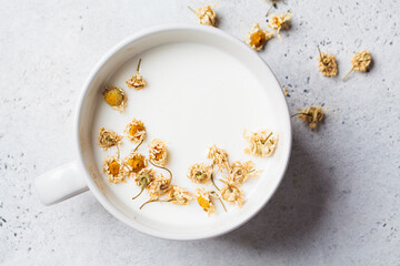 Chamomile moon milk in white cup. Ayurveda drink, chamomile latte tea.