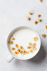 Chamomile moon milk in white cup. Ayurveda drink, chamomile latte tea.