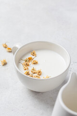 Chamomile moon milk in white cup. Ayurveda drink, chamomile latte tea.