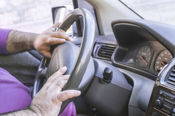 Man driving a car. The person drives a car in Europe or USA