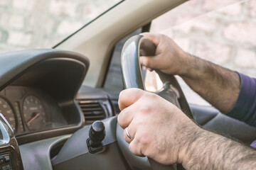 Man driving a car. Person drives a right-hand drive car in England, Japan or India.