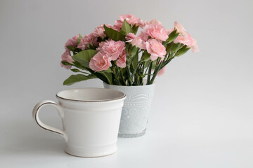 Breakfast in the morning with Mini Carnation flowers in a white glass on white background