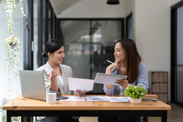 Asian business adviser meeting to analyze and discuss the situation on the financial report in the meeting room.Investment Consultant, Financial advisor and accounting concept