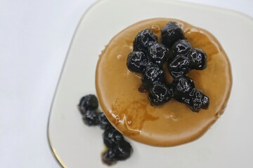 Japanese Souffle Pancake. A plate of fluffy pancake with Cappucino Boba topping isolated on white background. Top view. Close up
