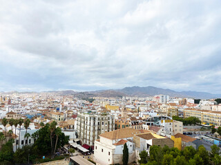 Fototapeta na wymiar high angle view of the city from Alcazaba de Malaga on a cloudy day. one of the most famous attractions in Malaga, Spain. High quality photo