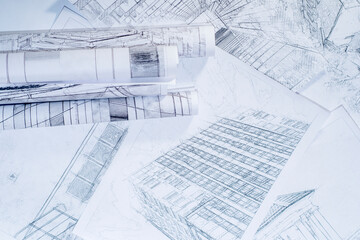Convolutions with drawings of buildings lying on sheets. Background with architectural plans.